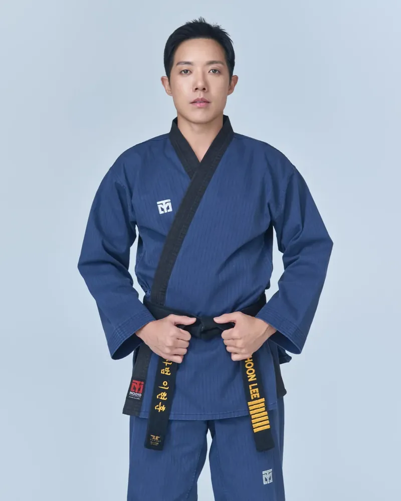 Master Hyunhoon Lee, founder of Leaders Taekwondo, in a navy uniform and black belt